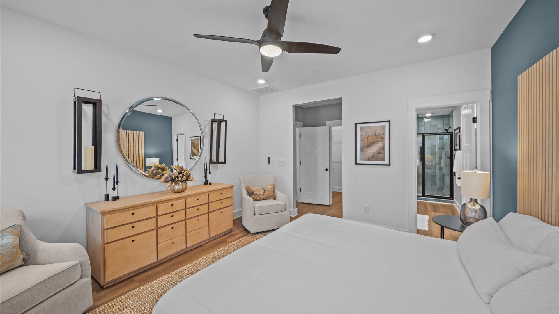 Elevated primary suite with tall windows, hardwood flooring, and vaulted ceilings at Aspen Ridge by DRB Homes in Lyman, SC