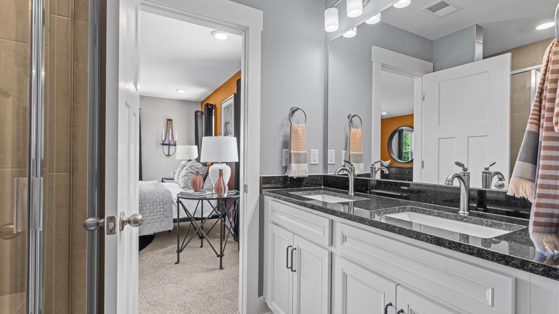 Modern en suite primary bathroom with luxe details and walk-in shower in two story townhome at Tyger Ridge by DRB Homes