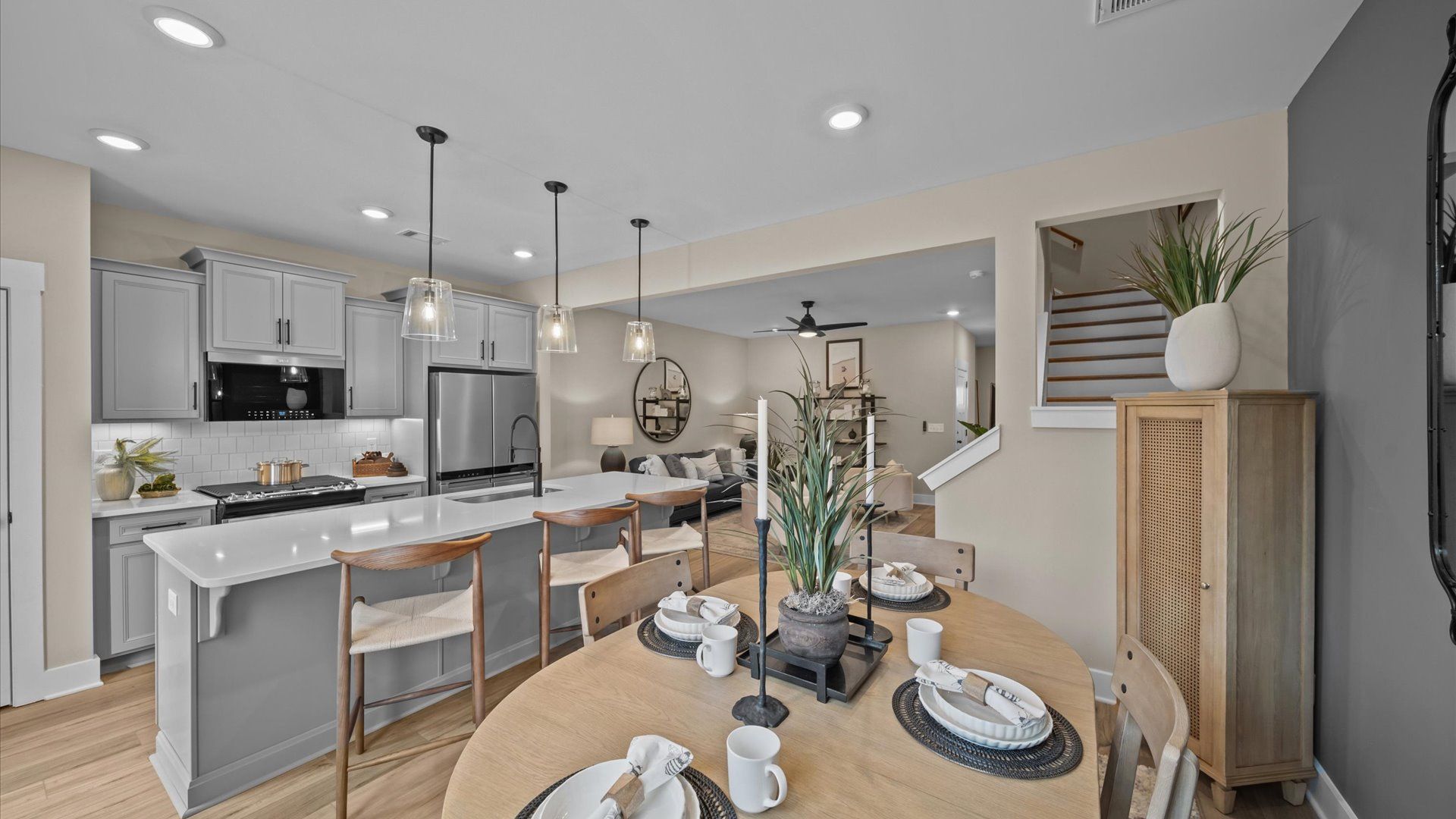 Inviting breakfast area with wood accents adjacent from open concept kitchen with large island with counterstools