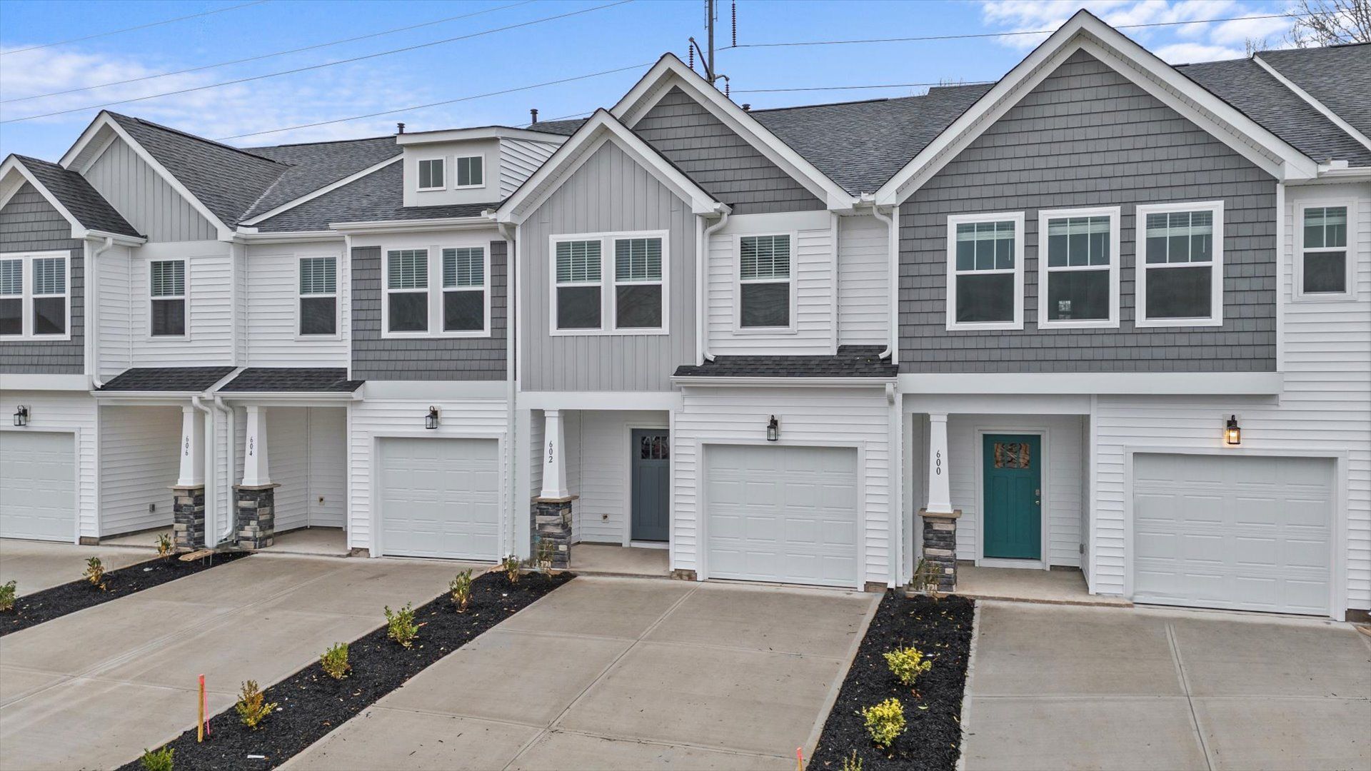 Light exterior two story townhome at Hickory Heights by DRB Homes near Downtown Greenville, SC