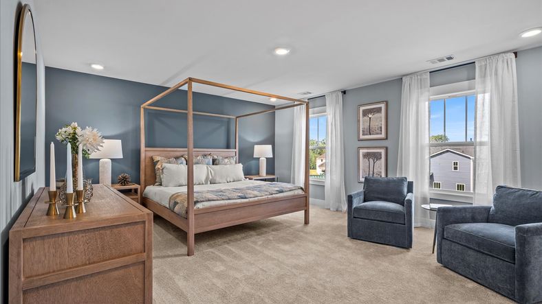 Plush carpeted, cozy, inviting primary suite with large windows at Magnolia Park by DRB Homes in Woodruff, SC