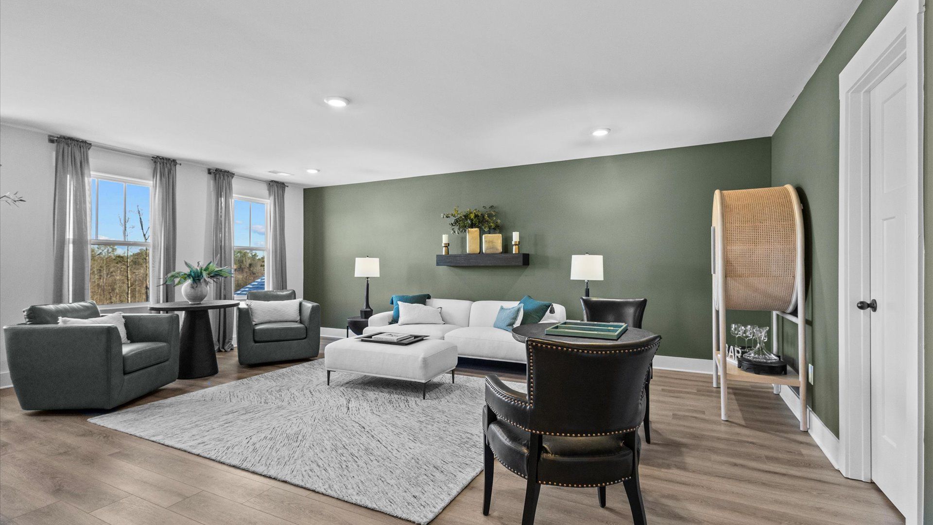 New two-story home with green accented loft space with hardwood flooring at Wells Crossing by DRB Homes in Seneca, SC