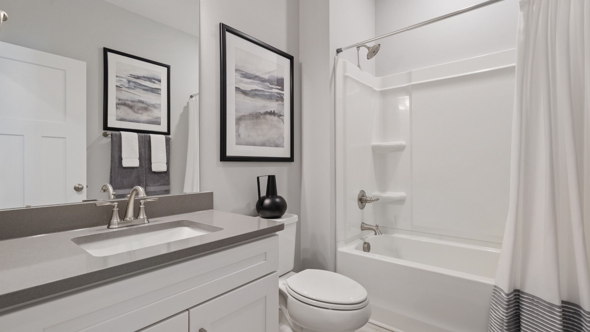Secondary bathroom with polished nickel hardware and gray accents at DRB Homes' Walnut Ridge in Inman, SC