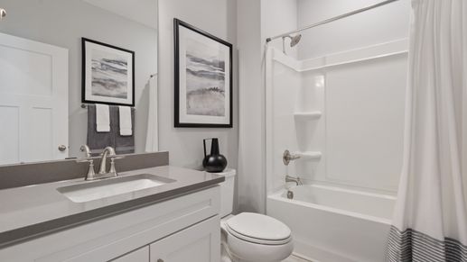 Secondary bathroom with polished nickel hardware and gray accents at DRB Homes' Walnut Ridge in Inman, SC