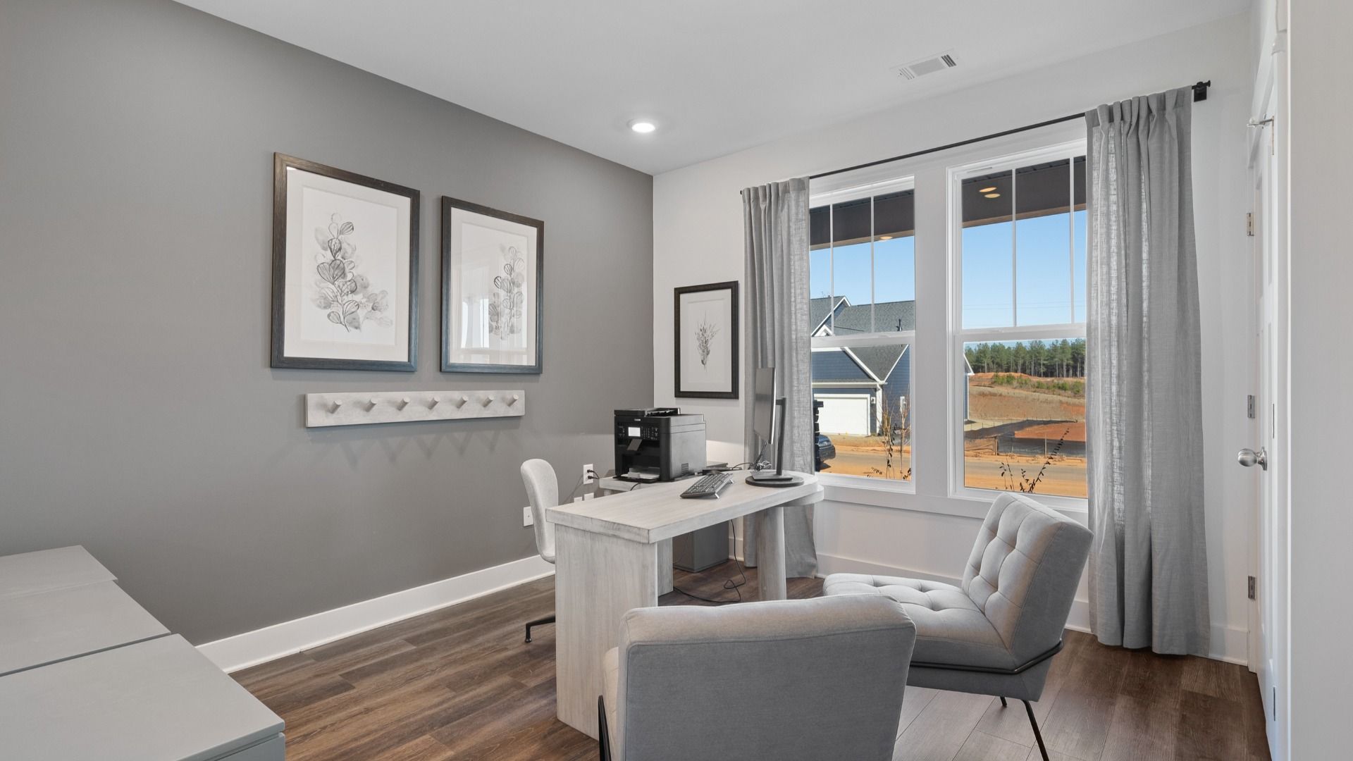 DRB Homes' Walnut Ridge with office space with gray accent wall, large windows, and hardwood flooring in Inman, SC