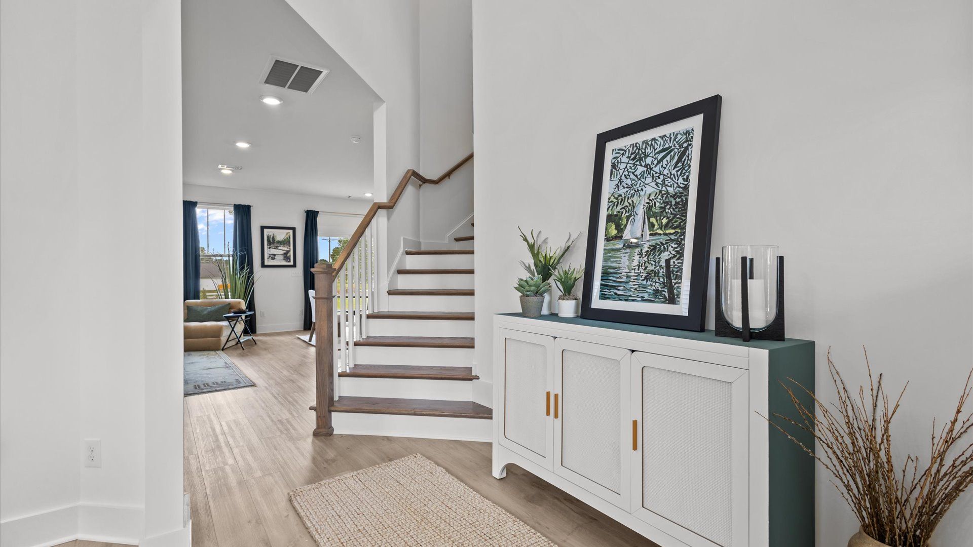 Woodglen by DRB Homes with Cameron floorplan with stunning entryway with hardwood flooring and vaulted ceilings