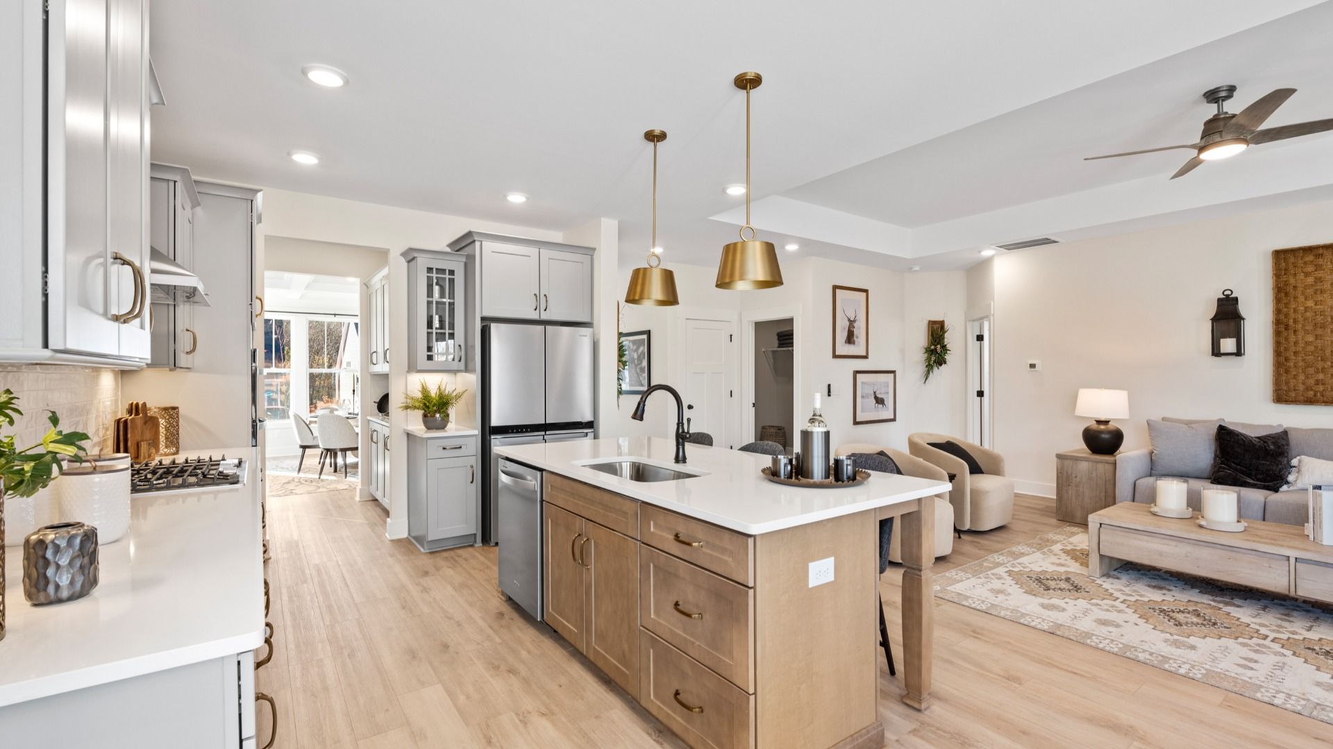 Luxury kitchen with gold accents, modern appliances, and wooden island at Woodglen by DRB Homes in Piedmont, SC