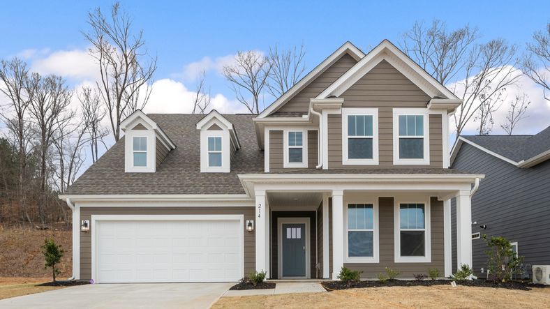 Stunning light gray exterior two story home with two car garage and large windows at Pelham Crossing by DRB Homes