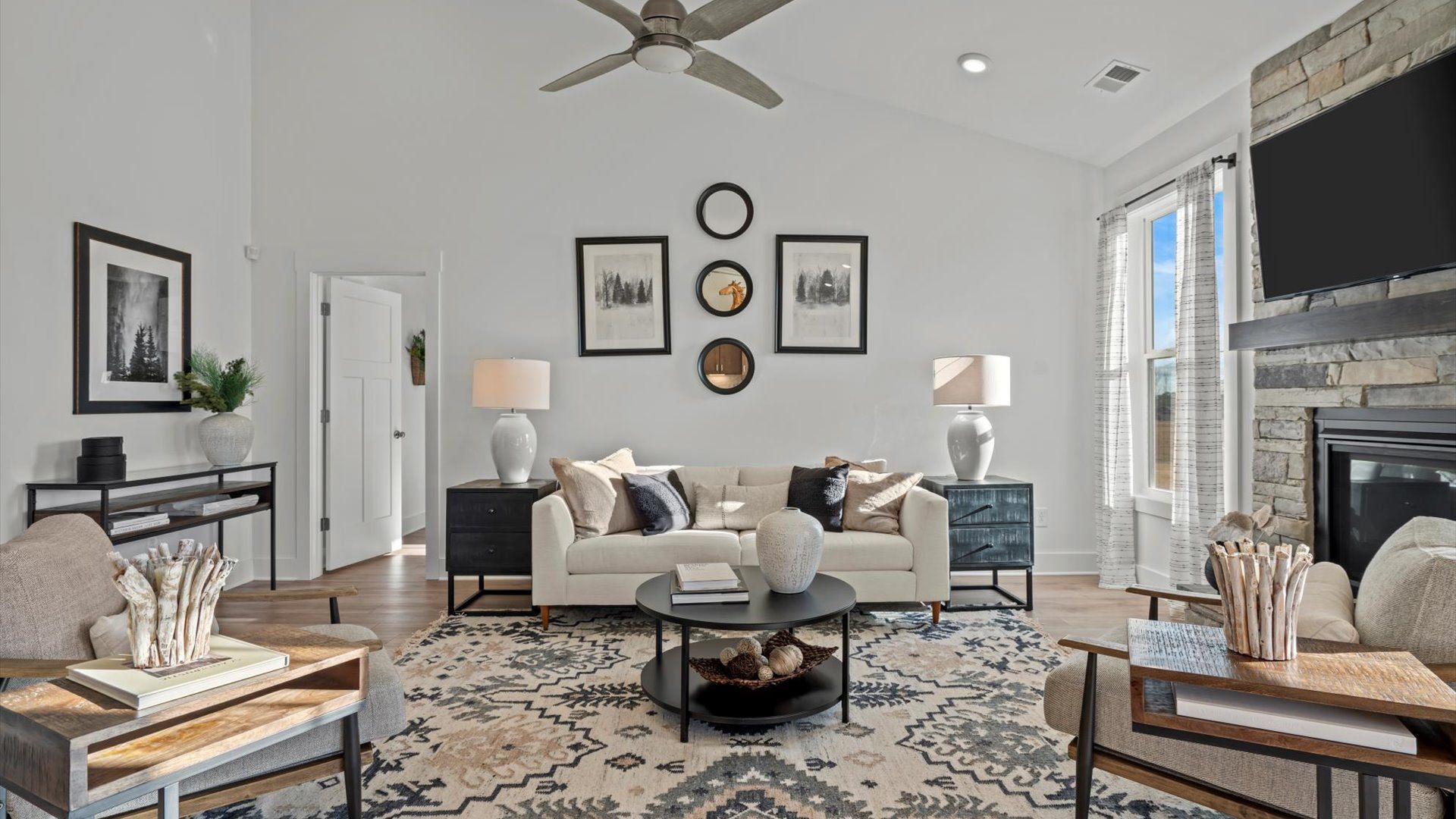 DRB Homes' Pelham Crossing with two story ceiling family room with stone fireplace and ceiling fan in Greenville, SC