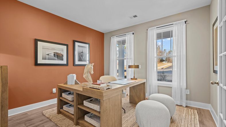 French door study space with orange accents, large windows, and hardwood flooring at Pelham Crossing in Greenville, SC
