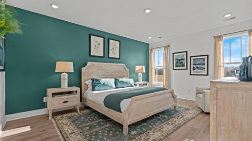 Serene primary suite with green accent walls and hardwood flooring at DRB Homes' Pelham Crossing in Greenville, SC