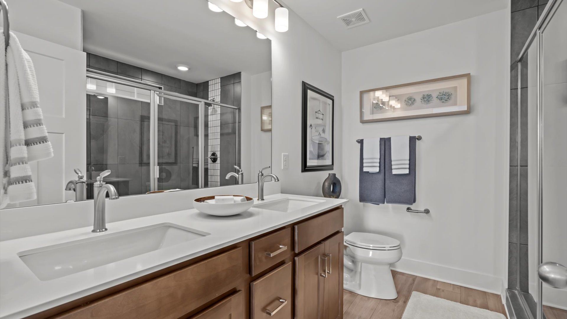 Luxe primary bathroom with gray tiled walk in shower at DRB Homes' Pelham Crossing in Greenville, SC