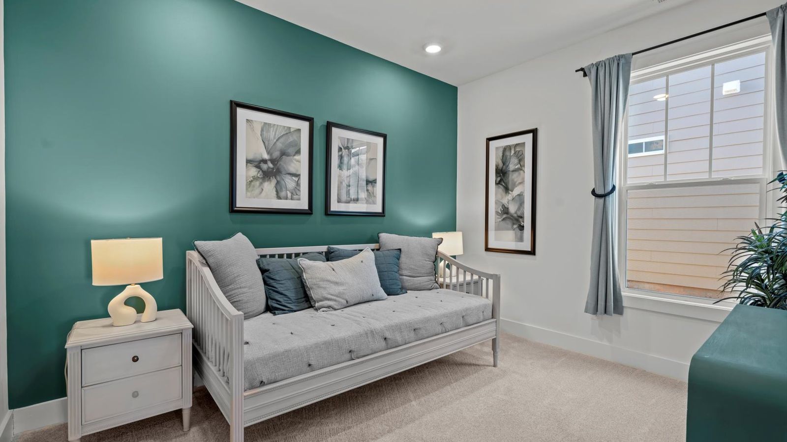 DRB Homes' Pelham Crossing with plush carpeted secondary bedroom and green accent wall in Greenville, SC