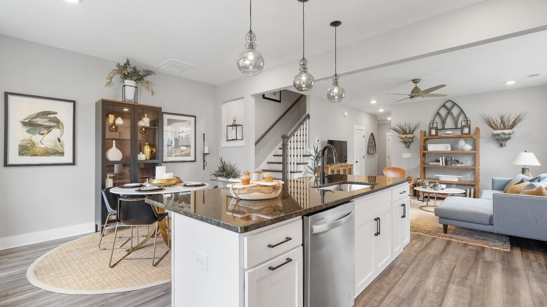 Black and white kitchen with modern accents and hardwood flooring at Barton Hollow by DRB Homes in Fountain Inn, SC