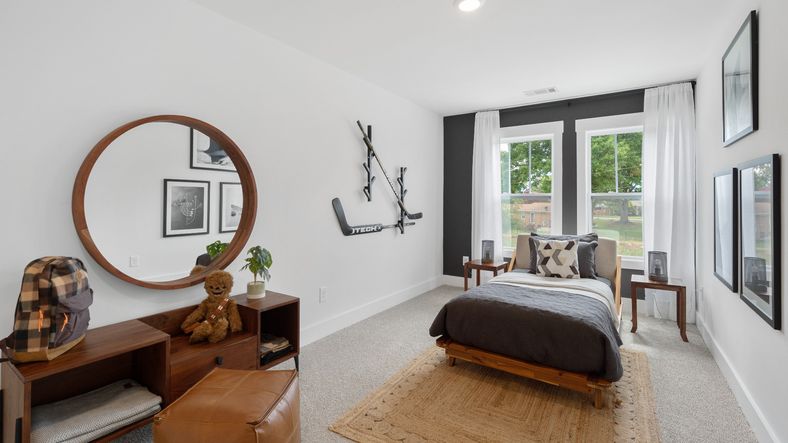 Cozy carpeted secondary bedroom with large windows at Barton Hollow by DRB Homes in Fountain Inn, SC
