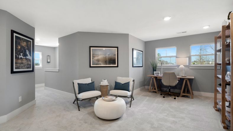 Cozy upstairs loft with plush carpet at Barton Hollow by DRB Homes in Fountain Inn, SC