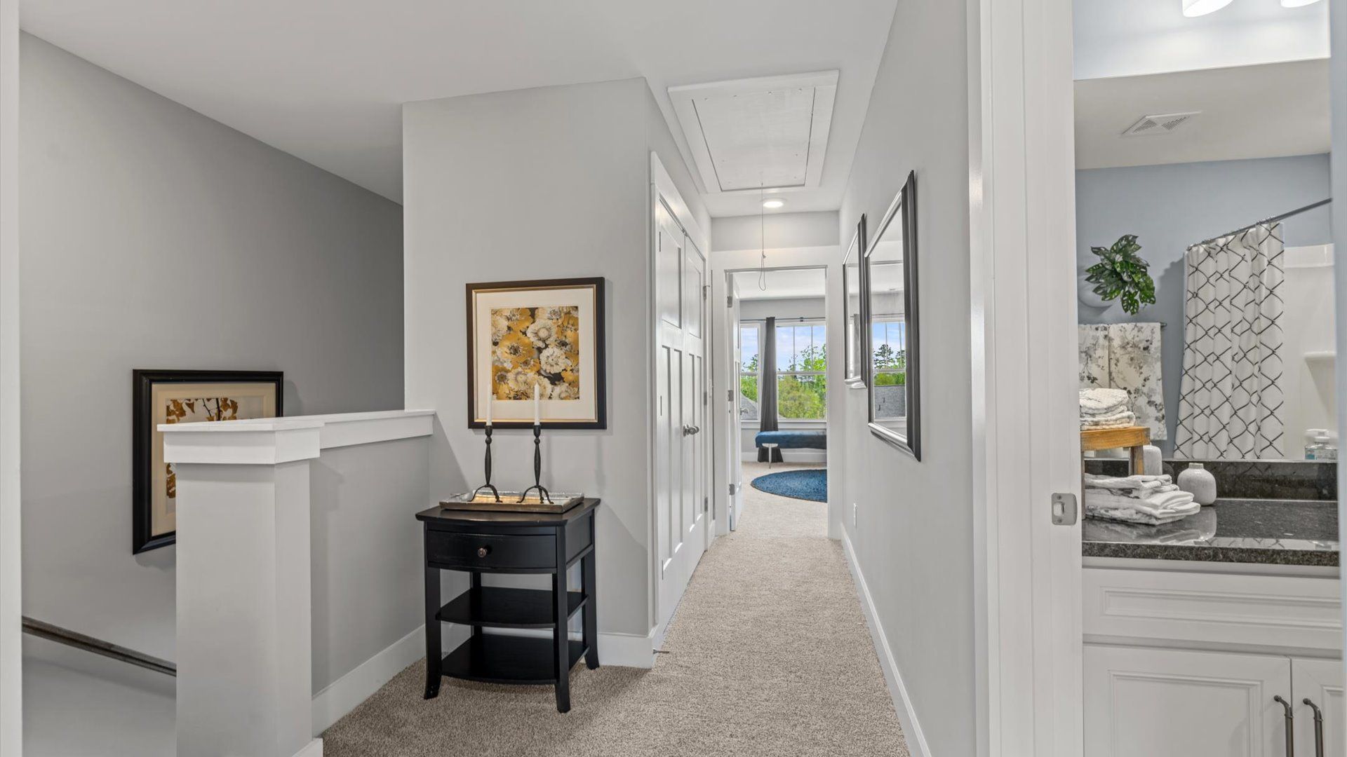 Carpeted hallway with elevated ceilings in two story townhome at Clayton Crossing by DRB Homes in Arden, NC