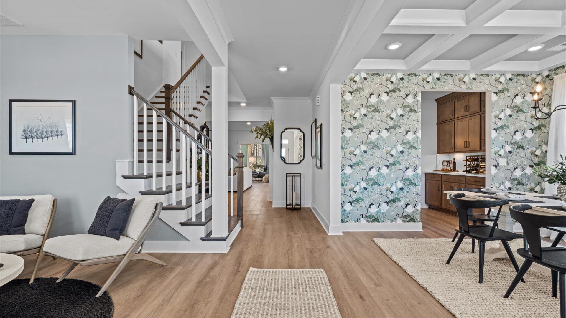 Stunning entryway with hardwood flooring, elevated ceilings, and views of den and dining room at Pinebrook by DRB Homes