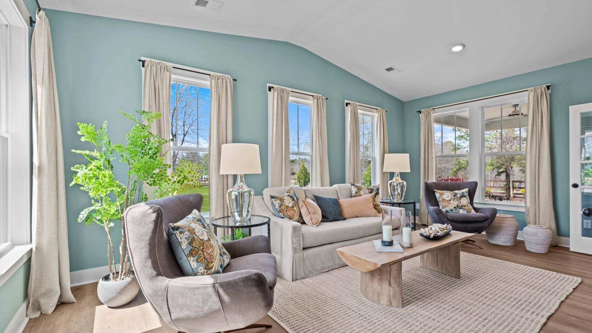 Perfect morning room with hardwood flooring and surrounding windows overlooking spacious private homesite at Pinebrook