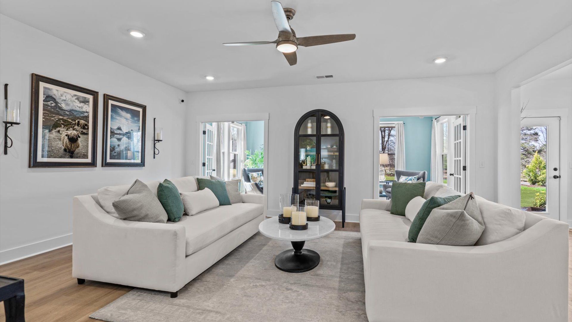 Large family room with hardwood flooring and ceiling fan at Pinebrook by DRB Homes in Woodruff, SC