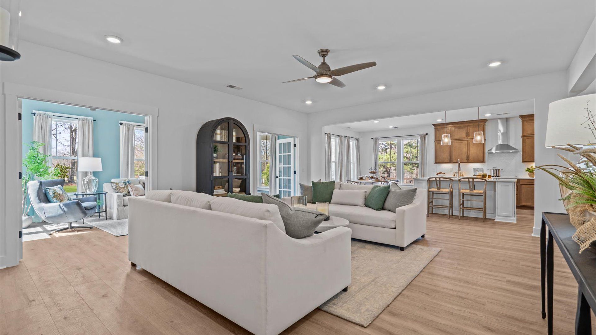 Large family room with elevated ceilings and hardwood flooring at Pinebrook by DRB Homes in Woodruff, SC