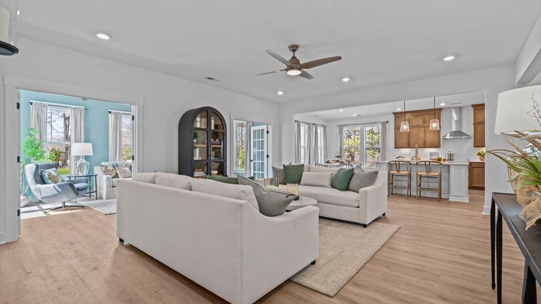 Large family room with elevated ceilings and hardwood flooring at Pinebrook by DRB Homes in Woodruff, SC