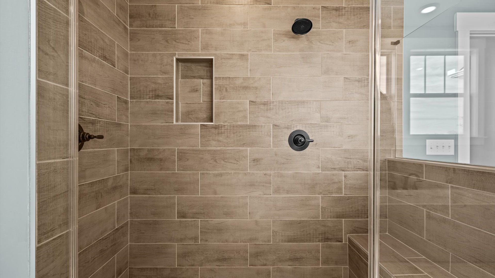 New two story home with large primary bathroom with tiled walk in shower at Pinebrook by DRB Homes in Woodruff, SC