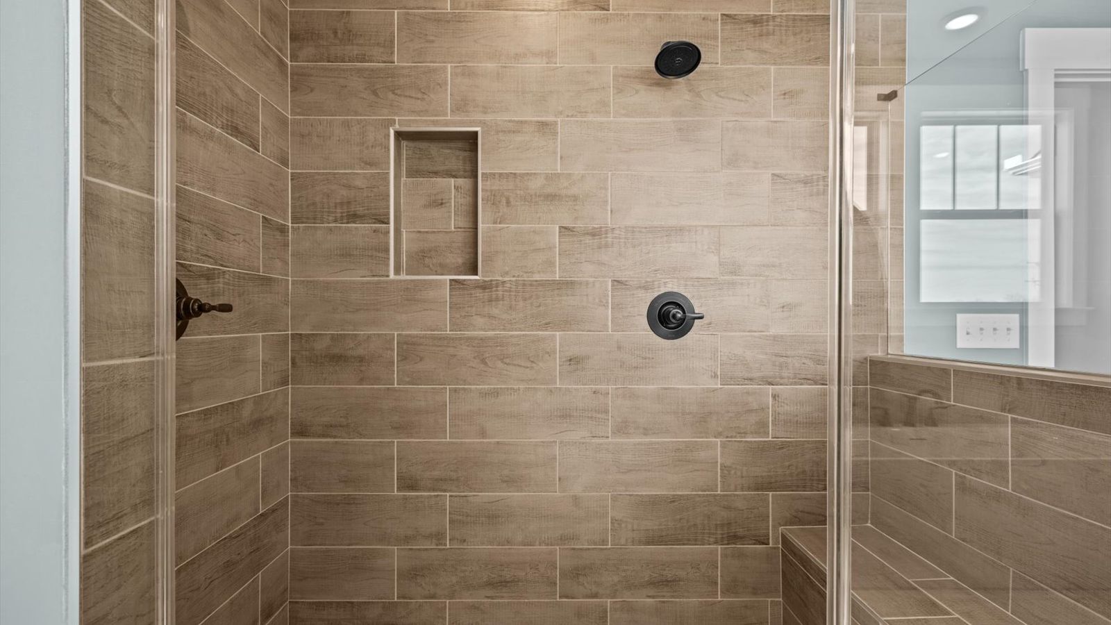 New two story home with large primary bathroom with tiled walk in shower at Pinebrook by DRB Homes in Woodruff, SC