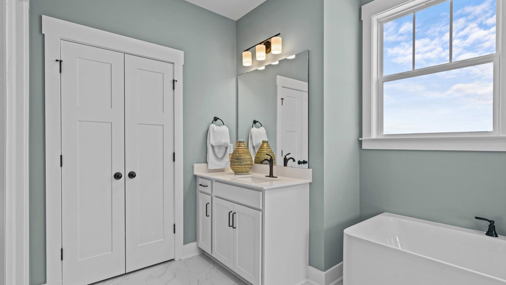 Primary Bathroom with large bath tub and separate vanities at Pinebrook by DRB Homes in Woodruff, SC