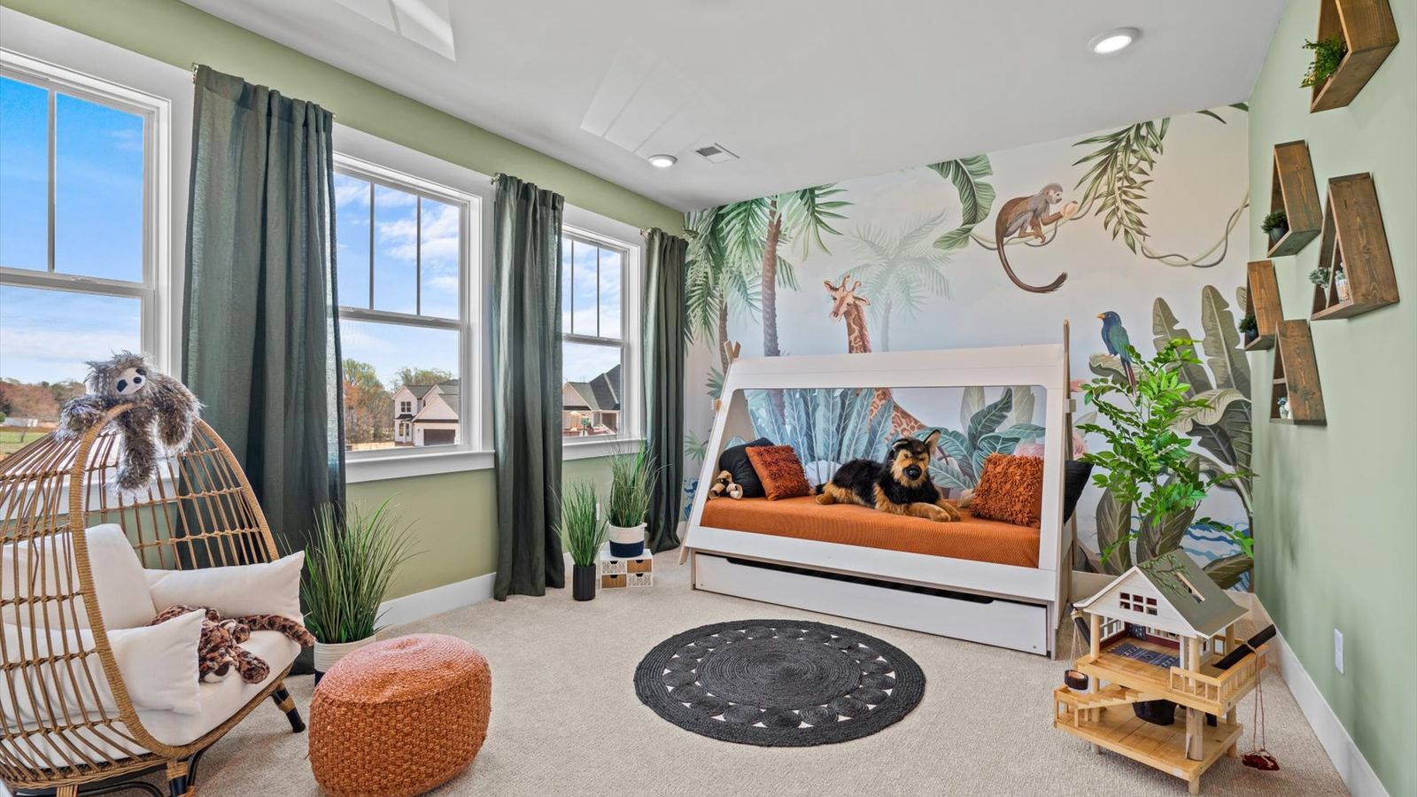Secondary bedroom with green accents, large windows, and plush carpet at Pinebrook by DRB Homes in Woodruff, SC