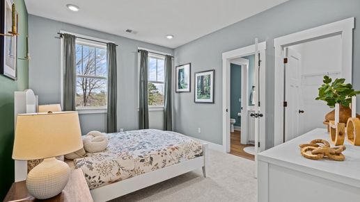 Window adorned secondary bedroom with plush carpet at Pinebrook by DRB Homes in Woodruff, SC