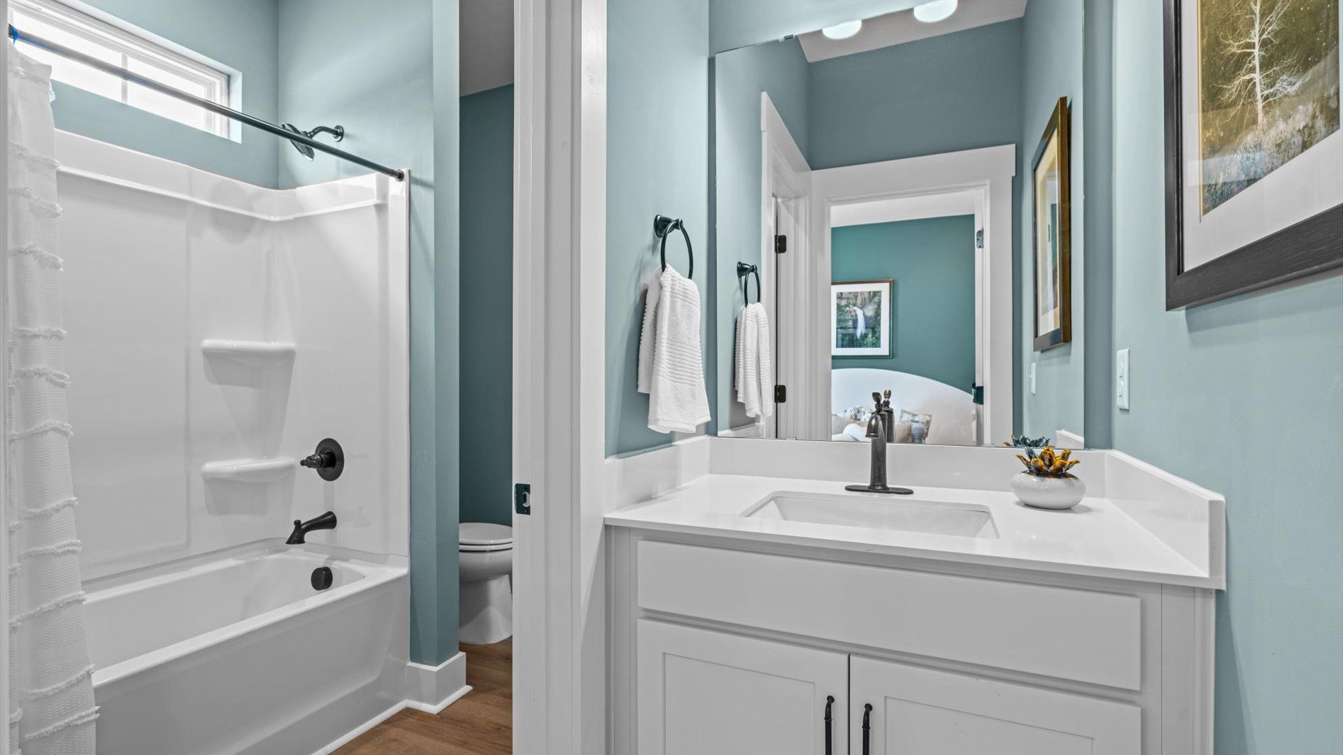 Secondary bathroom with two separate vanities and shared shower at Pinebrook by DRB Homes in Woodruff, SC