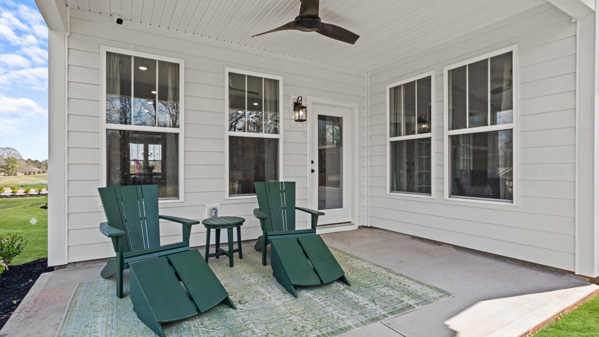 Private backyard with rear covered porch with ceiling fan at Pinebrook by DRB Homes in Woodruff, SC