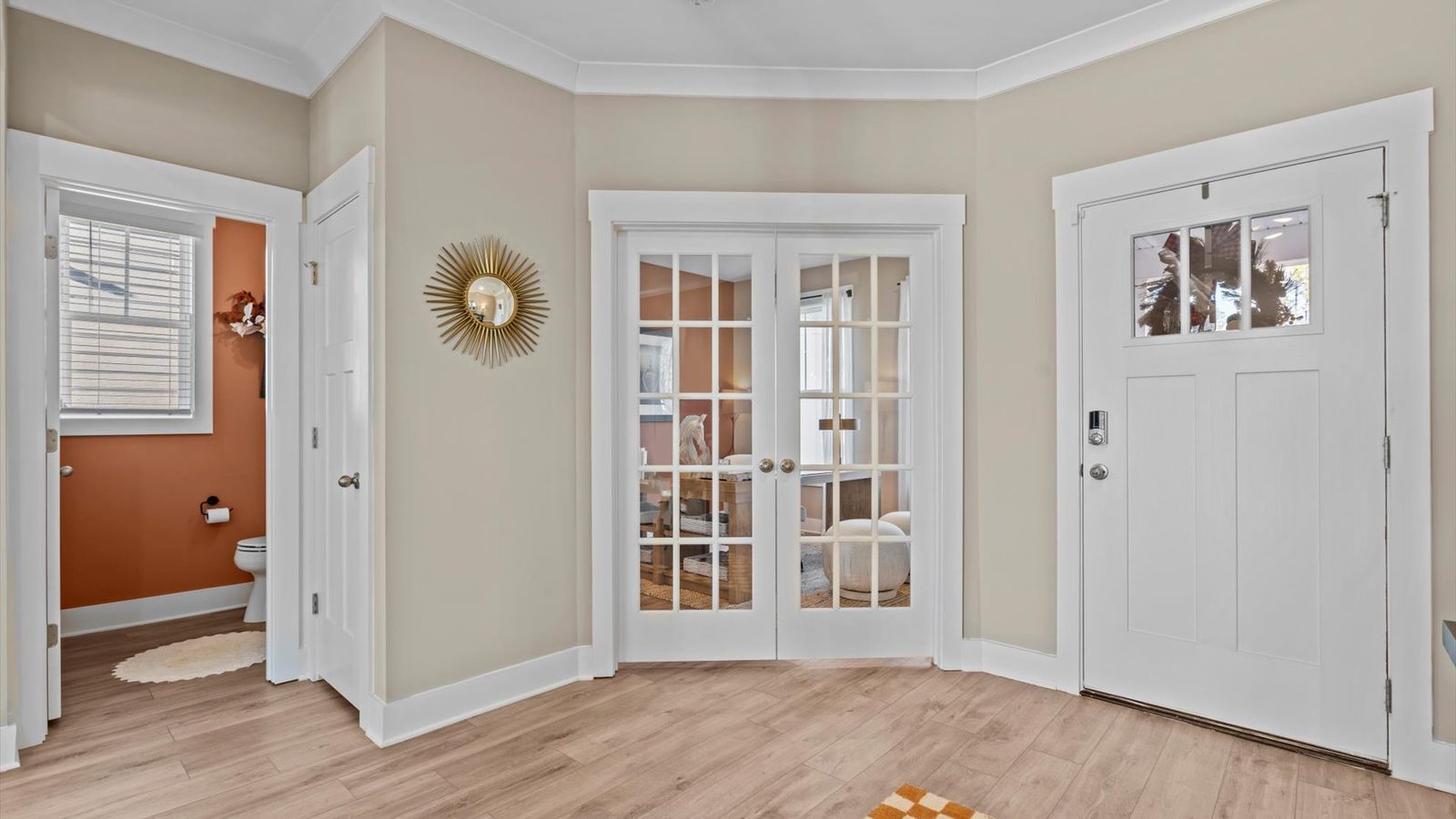 Inviting foyer with french door study and hardwood flooring in two story home at Mulberry Estates by DRB Homes
