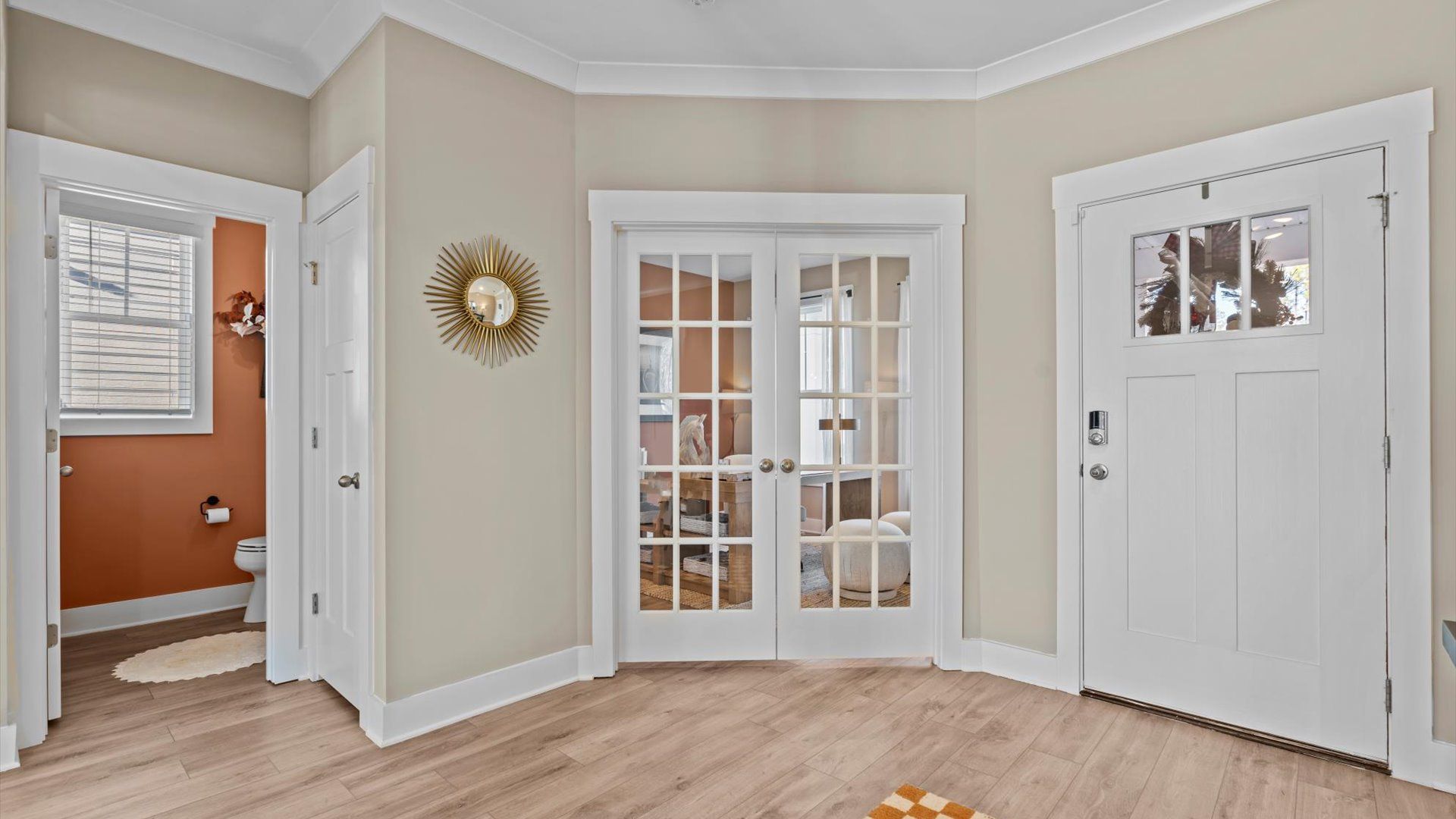 Inviting foyer with french door study and hardwood flooring in two story home at Mulberry Estates by DRB Homes