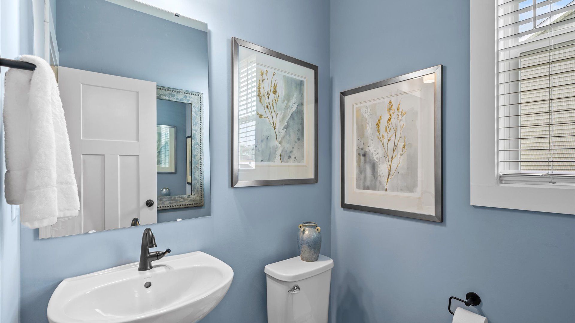 Calming, blue half bathroom in two story home at Mulberry Estates by DRB Homes in Simpsonville, SC
