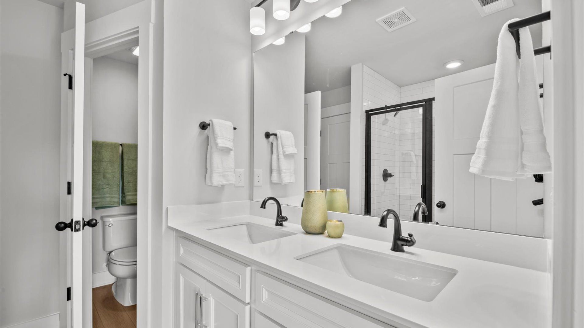 Primary bathroom with tiled walk-in shower and white quartz countertops in two story townhome in Piedmont, SC