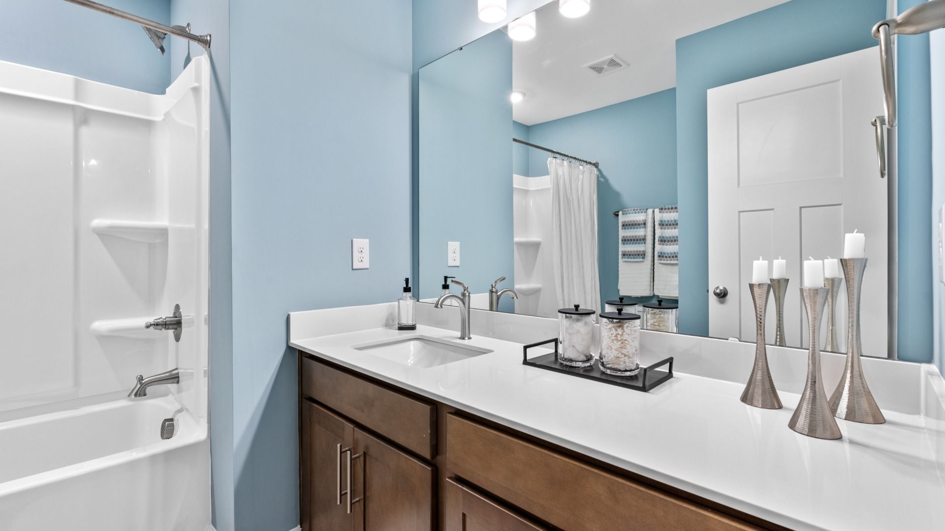 Serene secondary bathroom with ample counterspace in two story townhome at Saluda Crossing by DRB Homes in Piedmont, SC
