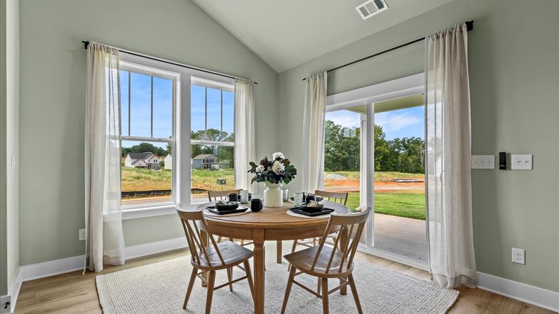 Serene breakfast area with large windows in two story home at Mulberry Estates by DRB Homes in Simpsonville, SC