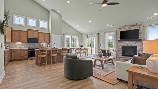 Spacious family room with hardwood flooring and stone fireplace in two story home at DRB Homes in Easley, SC