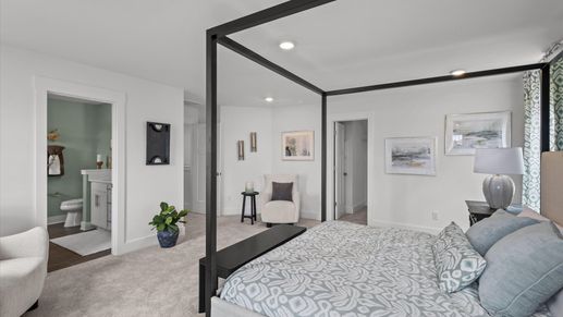 Serene primary suite with plush carpeted flooring in two story home at DRB Homes in Easley, SC