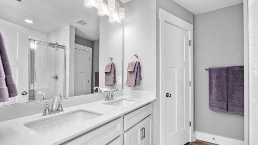 Double sink vanity in primary bathroom in two story townhome at Ransdell Pointe by DRB Homes in Spartanburg, SC