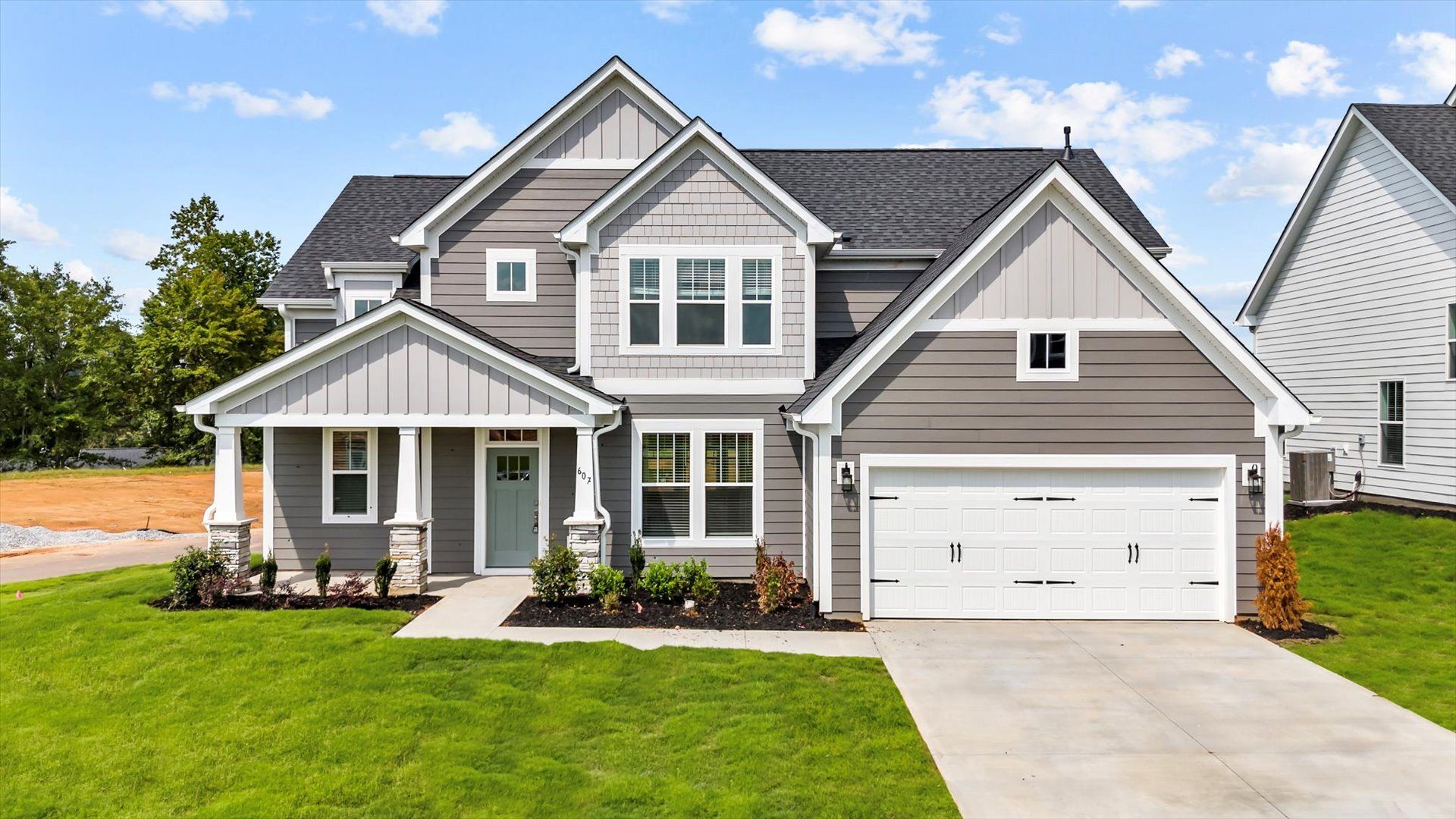 2 story single family home, all white with a 2 car garage