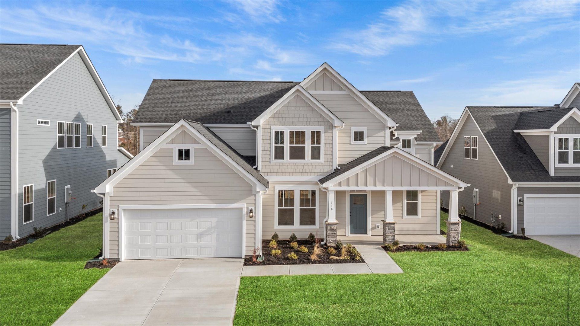 2 story single family home, all white with a 2 car garage