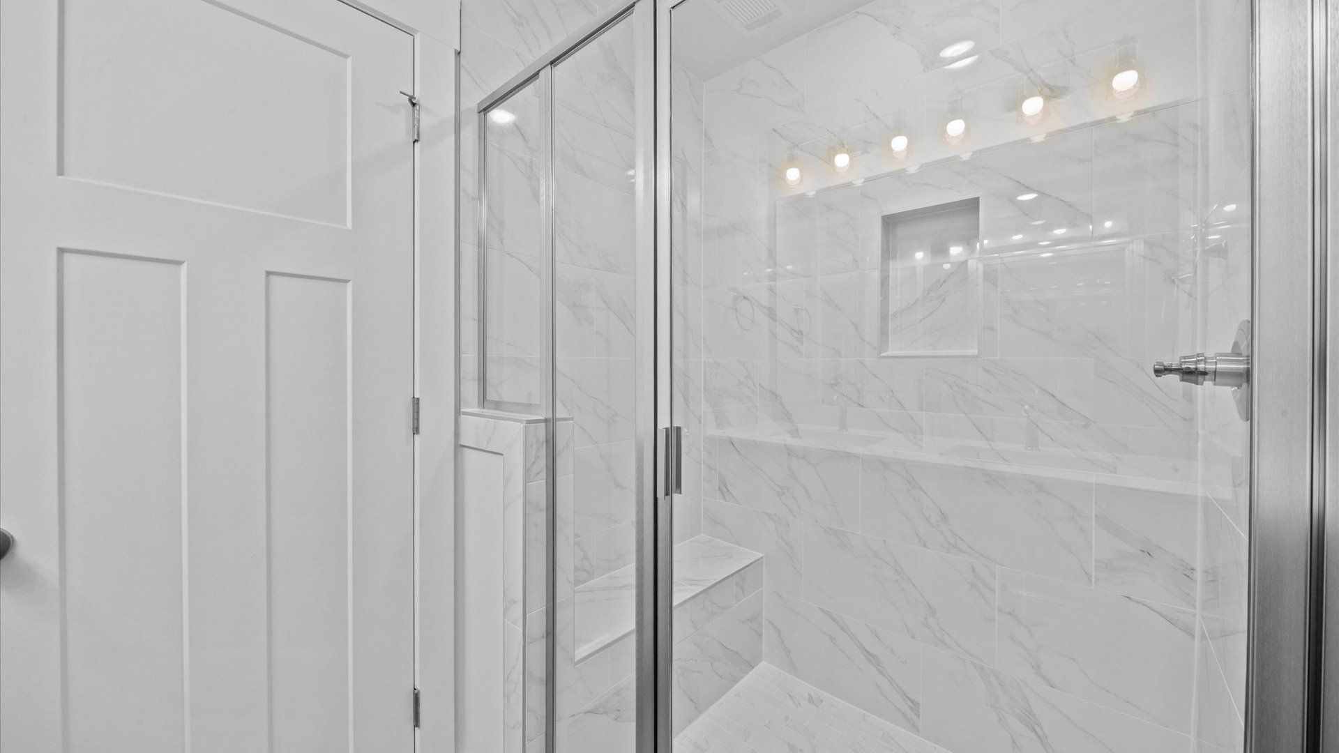Modern en suite primary bathroom with luxe details and walk-in shower in two story townhome at Hickory Heights by DRB Homes