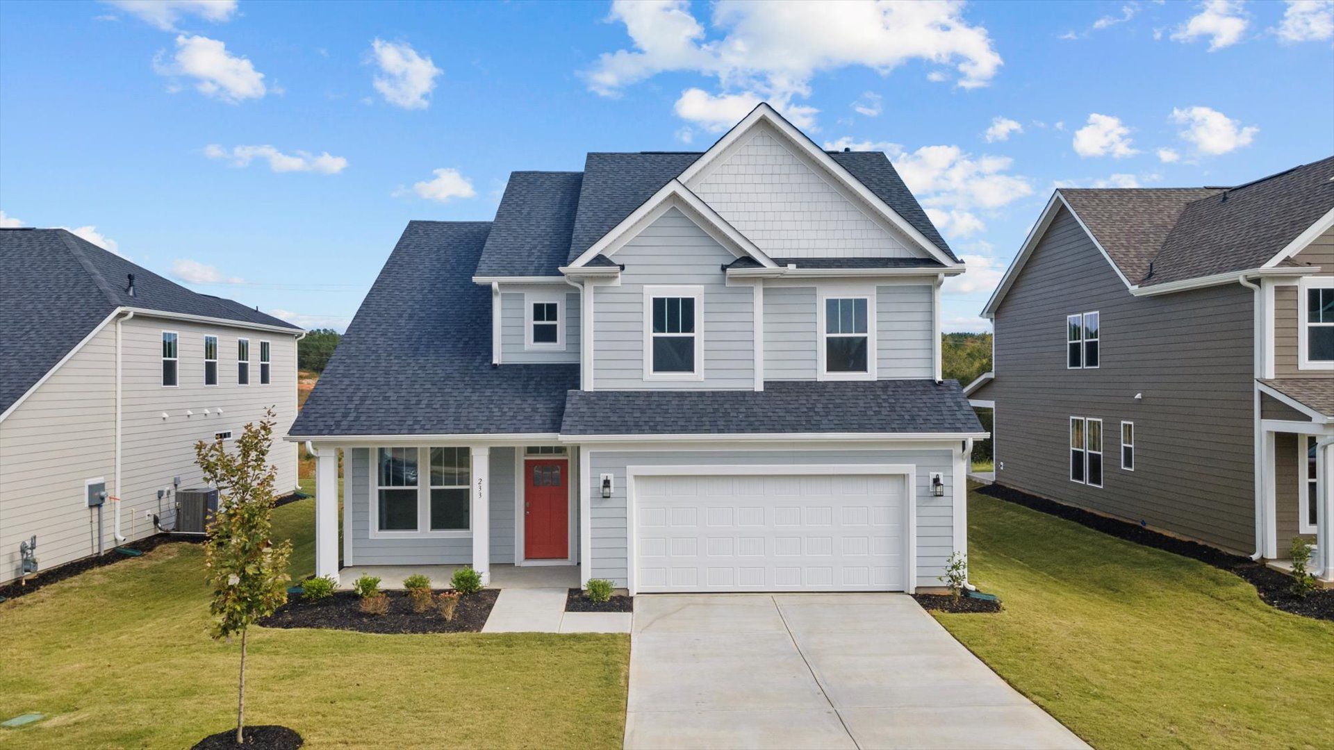Home with notable street presence with tasteful elevation and thoughtful landscaping at Harrier Point