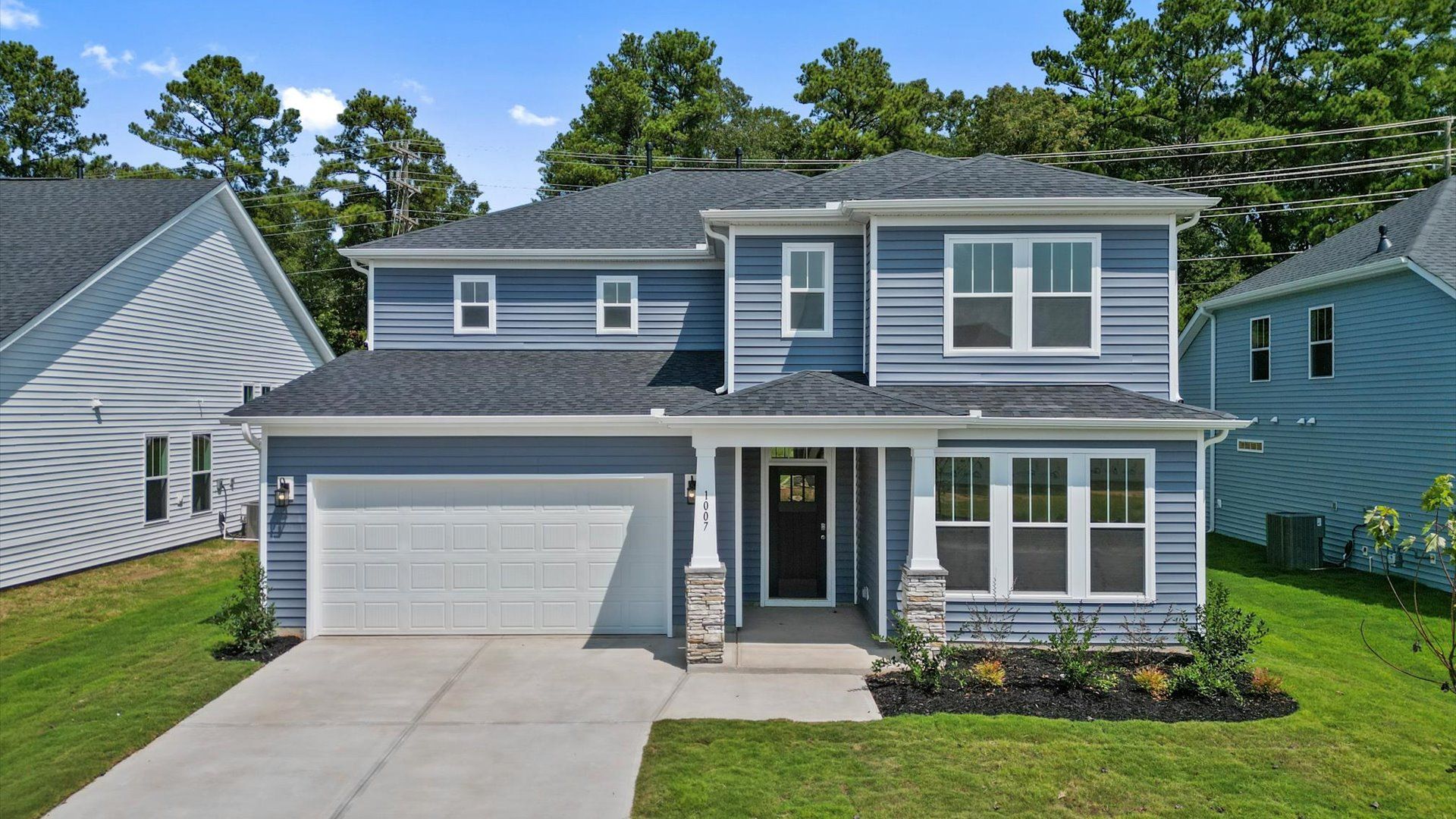 Two story blue exterior Drayton floorplan at Mulberry Estates by DRB Homes in Simpsonville, South Carolina