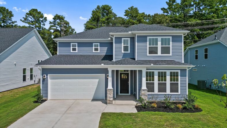 Two story blue exterior Drayton floorplan at Mulberry Estates by DRB Homes in Simpsonville, South Carolina