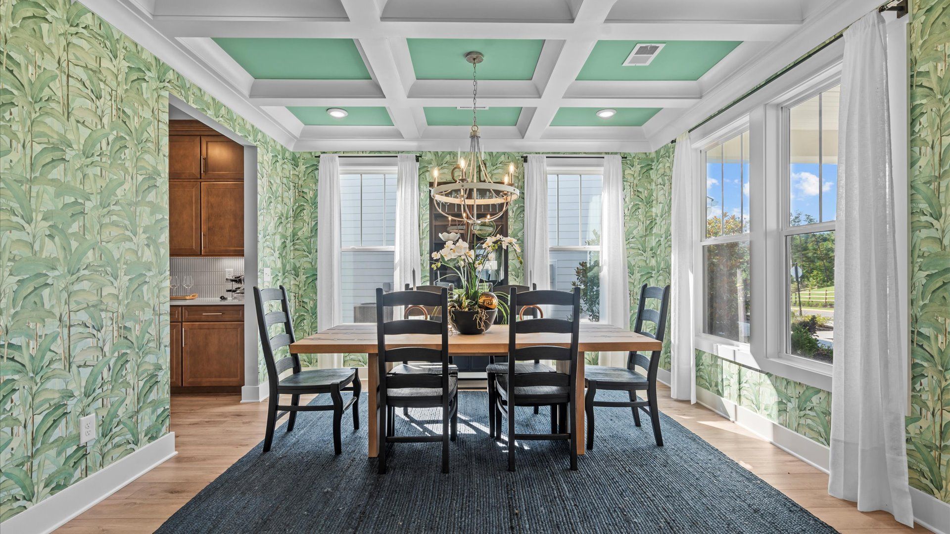 Memorable meals start beneath a coffered ceiling in this elegant and functional dining room located in Seneca, SC