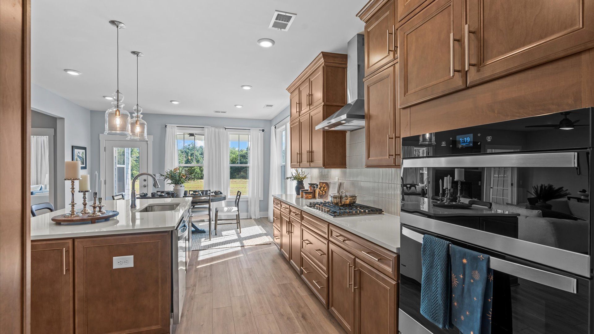 Highly skilled craftsmanship shines in this modern kitchen with pendant lighting and a central island focal point